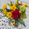 Yellow daisies, green hydrangea, red roses. solidago arranged in a cube vase