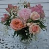 Peach garden roses, spray roses, peonies, alstromeria and baby&#039;s breath arranged in