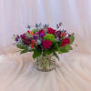 This lively arrangement features an eye-catching mix of red, orange, purple, and