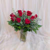 A classic display of a dozen vibrant red roses, elegantly arranged to