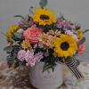Spring hat box arrangement filled to the brim with vibrant spring florals