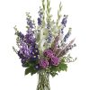 Lavender and white sympathy flowers make a grand statement in this joyful
