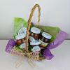 Variety of SeaQuist Orchards goods, nestled in a basket adorned with ribbon