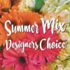 Mix of seasonal flowers in a glass vase