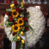 Beautiful solid heart sympathy arrangement with white carnations and mixed flowers. 

This
