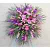 A lovely standing spray with purple and pink flowers. 

