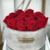 12-14 everlasting red roses carefully placed on a beautiful round cement signature