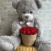 Large fluffy teddy bear with preserved roses in a basket