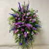 This Standing Spray on an Easel includes Blue Delphinium, Purple Larkspur, Purple