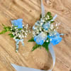 Made from fresh flowers, a corsage looks like a petite flower arrangement
