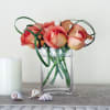 Orange roses in a clear glass vase. A delight for any occasion.