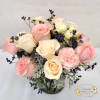This arrangement includes pink roses, white roses, white spray roses, pink carnations
