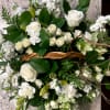 A tranquil mixed arrangement that arrives in a natural wicker basket, showcasing