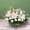 A tranquil mixed arrangement that arrives in a natural wicker basket, showcasing