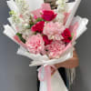 A graceful bouquet featuring French roses, spray roses, and fragrant matthiola. Wrapped