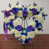 Blue flowers with deep purple roses and white flowers.