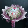 Wrapped bouquet with Roses, alstroemeria, fluffy greens, and a kitty plushie. 

can