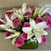 White Lilies and 12 Pink Roses with greens arranged in a glass