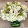 White Roses with White Hydrangeas mixed with green Cymbidium Orchid flowers. Arranged