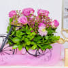 A whimsical floral arrangement featuring vibrant pink roses and lush greenery, elegantly