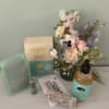Gorgeous box full of wellness products in mint green and sage colors.