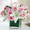 Soft pink roses mixed in with beautiful white lilies in a square