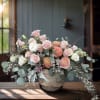 A soft, garden-style composition featuring blush roses, peach ranunculus, ivory lisianthus, and
