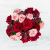 This arrangement includes purple cymbidium orchids, red roses, &amp; pink roses. Truly