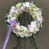 Assorted florals combine to make a lovely tribute presentation.  Please feel