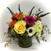 A beautiful clear glass cylnder vase lined with bear grass filled with