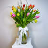 An arrangement of tulips carefully placed in a vase, highlighting their natural