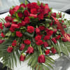 Red roses, red carnations and tea leaves in this beautiful tribute for