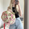 A graceful bouquet composed of soft blush roses, fluffy hydrangeas, delicate ranunculus