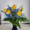 Yellow roses engulfed in blue stock, blue baby&#039;s breath a assorted greens