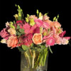 This luxurious floral arrangement features the soft, romantic hues of peach roses