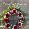 Vibrant red panther roses. blue oceanand white chrysanthemum, alstroemeria, grevillea and leather