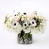 A soft-spoken stunner of Anemone, Ranunculus, Hydrangea, Calla Lilies, Brunia, and garden
