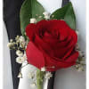 A red rose boutonniere with greenery is a timeless and elegant accessory