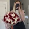 A passionate trio of red, ivory, and blush roses arranged into one