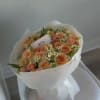 A bright and cheerful mix of tangerine and peach roses, playful chamomile