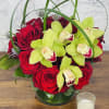 This stunning arrangement combines the fiery elegance of red roses with the
