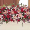 Casket spray with roses, stargazer lilies, larkspur, stock with a variety of