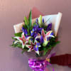Six iris join with star fighter lilies  in a simple wrapped