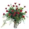 A beautiful arrangement of red roses and specialty greenery