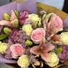 Delicate and graceful, this romantic arrangement features soft pink, lavender, and white