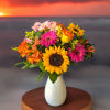 Introducing our Summer Sunset bouquet, where vibrant oranges, pinks, and yellows dance