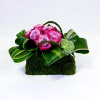 A floral moss purse designed of lavender roses accented by aspidistra leaves