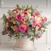 A lavish blend of vibrant pink lisianthus, soft peach roses, and silver