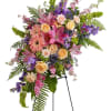 Share your feelings with this bountiful, cascading standing spray of feminine sympathy