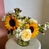 A beautiful mixture of sunflowers, roses and other subtle seasonal flowers. 
